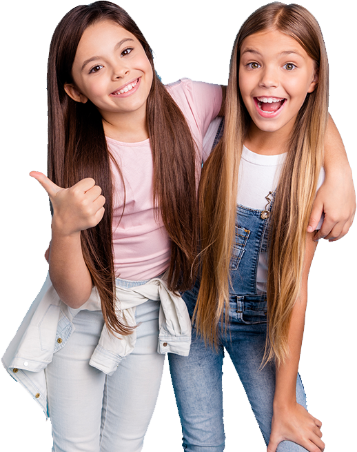 Two young girls hugging and giving a thumbs up to the camera